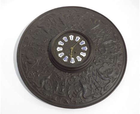 A cast metal wall hanging clock with ornate dial having enamel Roman numeral cartouches on an ornate cast metal backing,