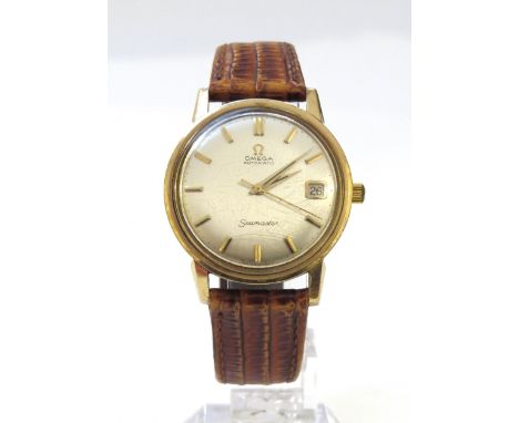 OMEGA: A 9ct gold cased Omega Seamaster Automatic wristwatch on reptile leather strap, with Omega buckle, in associated Omega
