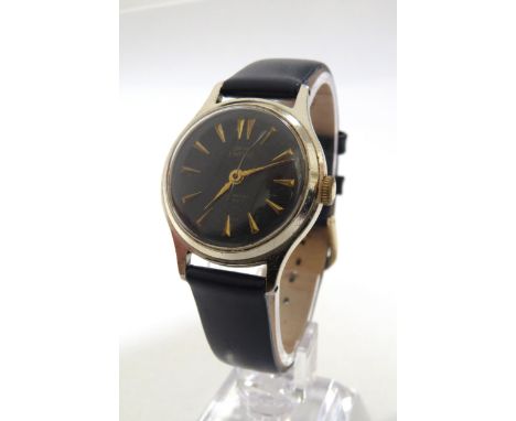 A Smiths Empire black dial gentleman's wristwatch, blue engine turned dial with gilt arrow markers in steel case, on blue lea