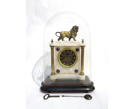 A continental white marble and gilt metal mantel clock surmounted by a cast metal lion all under a large glass dome, column f