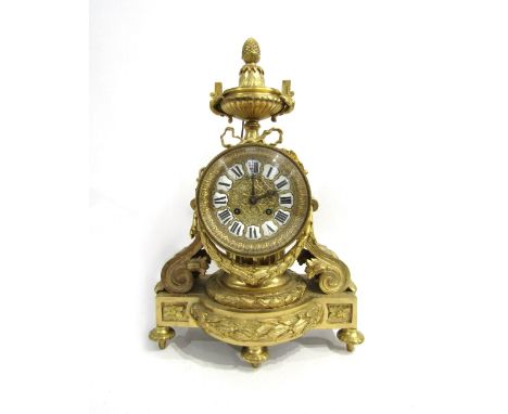 A 19th Century French gilt metal mantel clock, the movement drum held by a column, with acanthus and scroll form supports, or