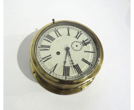A brass cased ships clock with Roman numeral dial, subsidiary dial below 12, missing hand