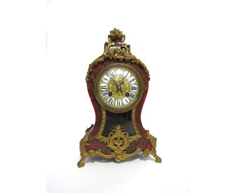 A French boulle clock with ornate gilt metal inlaid tortoiseshell case, enamel cartouche Roman numerals to dial, with twin ba