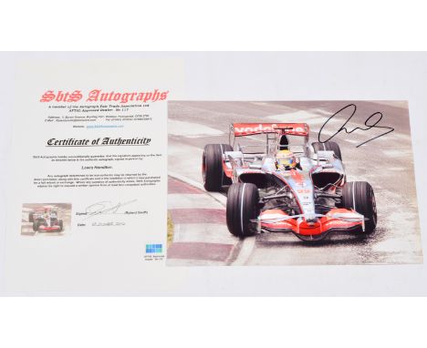 Lewis Hamilton autograph, on a photograph print of him driving the Vodafone Mclaren Mercedes F1 car, with Certificate of Auth