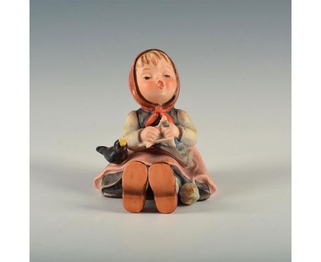 Figure of a seated girl knitting.&nbsp; Base marked model number 69. W. Goebel&nbsp;backstamp. Artist: Arthur Moeller Issued: