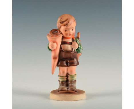 Figure of a boy with a backpack holding a paper cone. The cone in boy's right arm is called Schultute or Zuckertute, a paper 