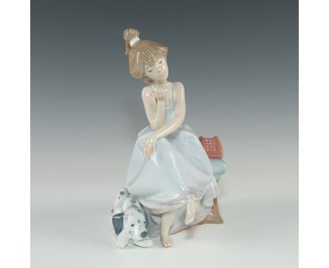 Glazed light blue, tan. Seated girl on phone with dalmation puppy A Lladro figurine, model number 5466. With a glazed finish,