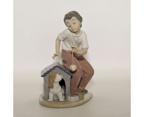 Boy with dog playing on a dog house - Lladro number 01005797. VAMOS A JUGAR Artist: Joan Coderch Issued: 1991 Dimensions: 7.7