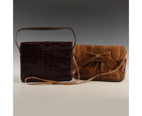 Clemente is rich saddle brown with piping; both have snap clasps. Both purses with straps, zippered pockets, and internally l