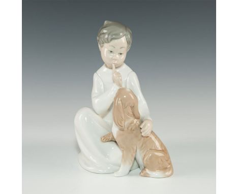 Glazed white, tan, light brown. Little boy and cockerspaniel. A Lladro figurine, model number 4522. With a glazed finish, mod