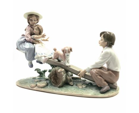 Two girls and boy playing on seesaw - Lladro number 01006169. Ninos En El Columpio (with box). Artist: Antonio Ramos Issued: 