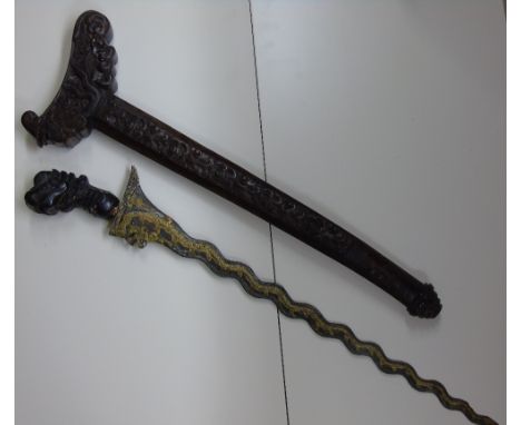 MALAYSIAN KRIS, HIGHLY DECORATED IN CARVED SCABBARD