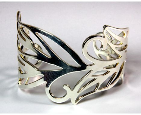 A contemporary pierced hallmarked silver bangle, W. 4.5cm.