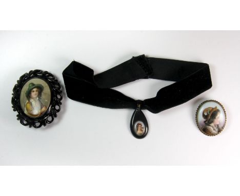 A Victorian jet mounted porcelain portrait brooch (a/f), a gilt metal porcelain portrait brooch and a further jet mounted por