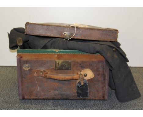 A vintage leather case with Military issue compass, boxed flying goggles, silver plated beakers, Sargeant's jacket, etc.