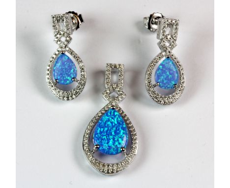 A pair of 925 silver earrings and matching pendant set with blue faux opals and cubic zirconia.