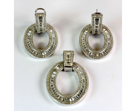 A 925 silver and cubic zirconia pendant and matching pair of earrings.