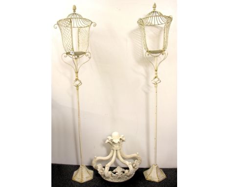 A pair of painted metal garden candle lantern stands (160cm) and an ornate wall bracket.