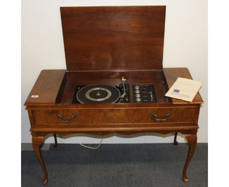 A Vintage Dynatron record player and radio in a walnut veneered cabinet.