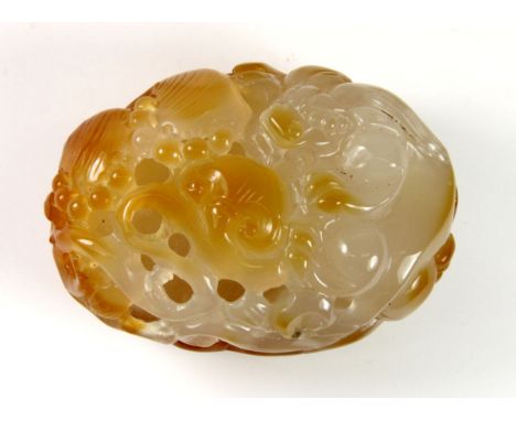 A finely carved Chinese banded agate scroll weight in the form of a dragon and lotus, W. 8.5cm.
