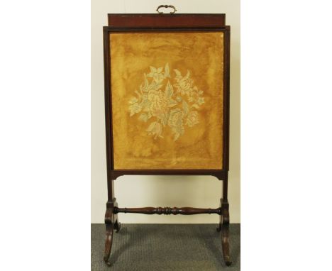 A lovely Edwardian mahogany firescreen with adjustable height and bookrest back, H. 105cm, W. 56cm.