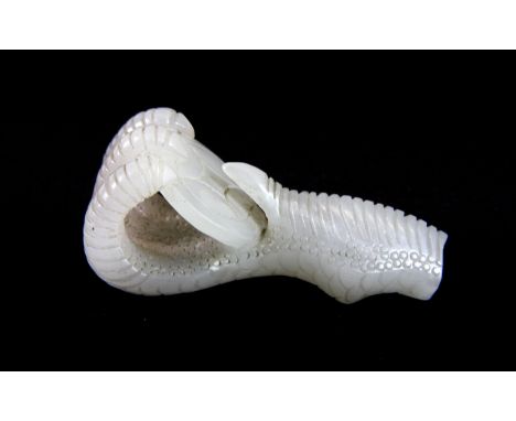 A 19th/early 20th century Chinese carved white jade eagles claw amulet, L. 6.5cm. Est. £300 - 400