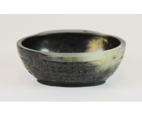 A Chinese carved jade libation cup, W. 11cm, H. 4cm.