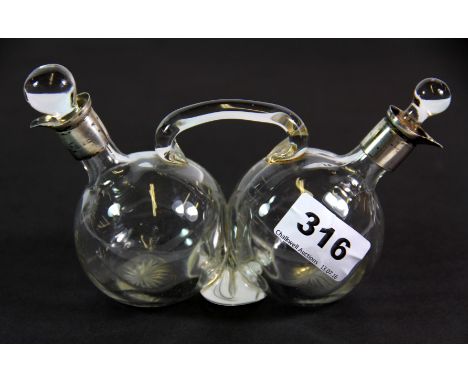 A hallmarked silver mounted glass oil and vinegar c.1929.