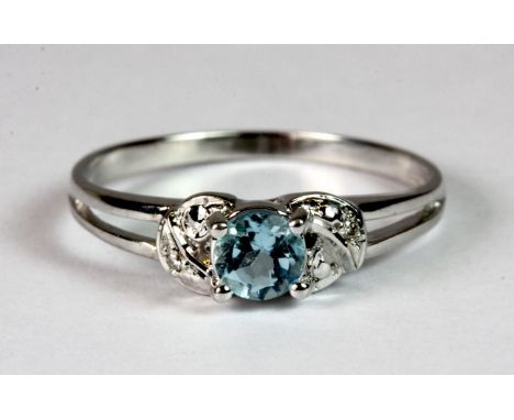 A 9ct white gold blue topaz and diamond ring, (K).
