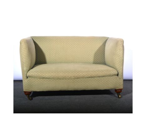 Small two seat green upholstered sofa, stained wood supports raised on castors W125cm x D75cm