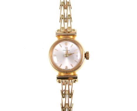 Omega - A ladies bracelet watch, the circular silvered baton dial in a 20/40 micron gold-plated case number 2963-62, manual w