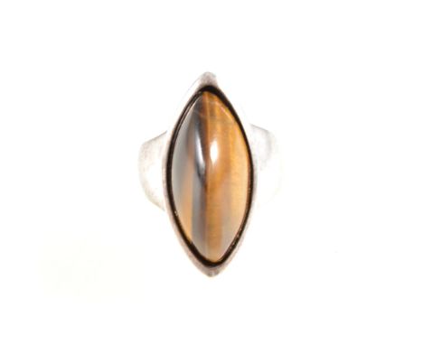A Danish silver ring set with tigers eye, the boat shape cabochon cut tigers eye 25mm x 12mm x 11mm high, collet set in a sil