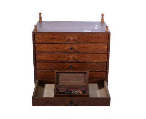 A four-drawer collector's cabinet, surmounted with chess pieces, together with a box containing a part chess set