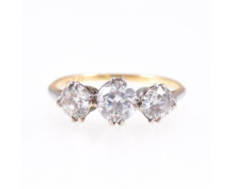 A diamond three stone ring, the old brilliant cut stones, slightly graduating in size, claw set in a yellow and white metal t