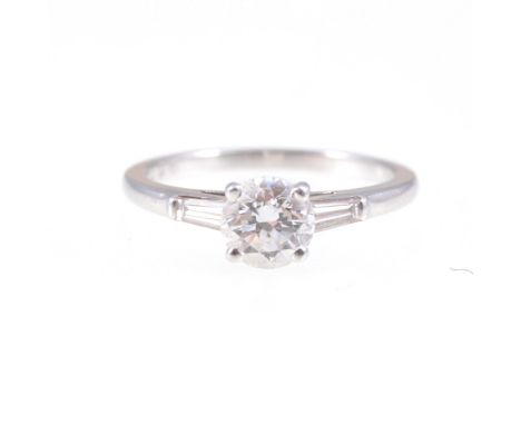 De Beers - A diamond solitaire ring, the brilliant cut stone claw set in a platinum single stone mount, plain 1.5mm wide shan