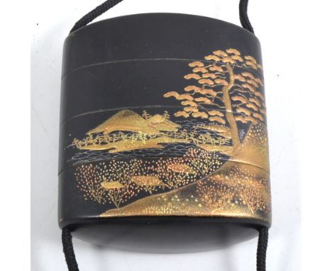 A four section lacquered maki-e Inro, late Edo period, with Mount Fuji landscape, with wooden netsuke carved with three frogs