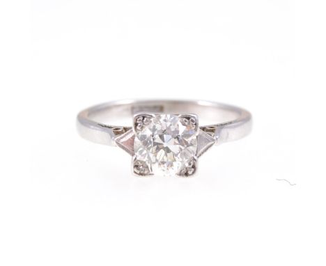 A diamond solitaire ring, the old brilliant cut stone square set in an all white metal mount, 2mm wide shank stamped Plat, ap