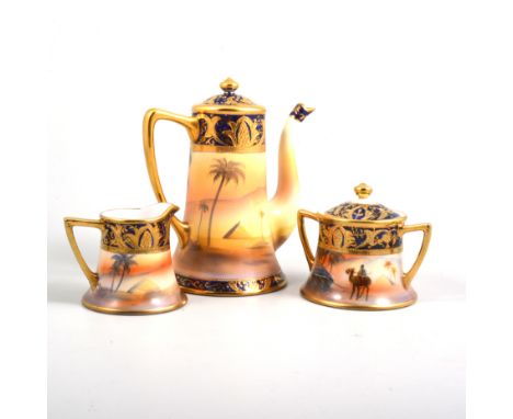 A Noritake desert scene coffee set with gilded highlights comprising coffee pot, milk, covered sugar, six cups and seven sauc
