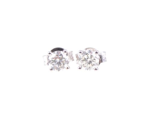 A pair of diamond single stone earrings, one brilliant cut diamond four claw set to each, in all white metal mounts stamped 7