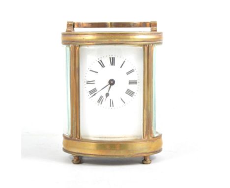 A French brass carriage timepiece in travelling case, plain white enamel dial with roman numeral chapter ring in an oval bras