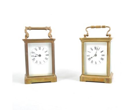 Two French brass carriage time pieces, both with travelling cases, white enamel dial with roman numeral chapter rings, oval b
