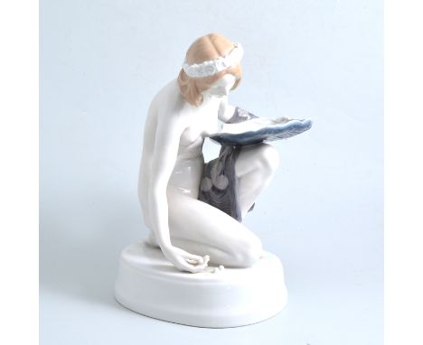 A Rosenthal porcelain figure of a maiden gathering pearls, signed K Himmelstoss 16cm high and seven Royal Copenhagen year pla
