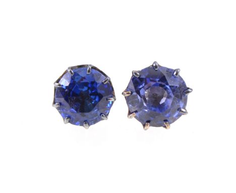 A pair of blue sapphire earstuds, the white metal earstuds each having a circular faceted sapphire, one 9mm the other 8.5mm d