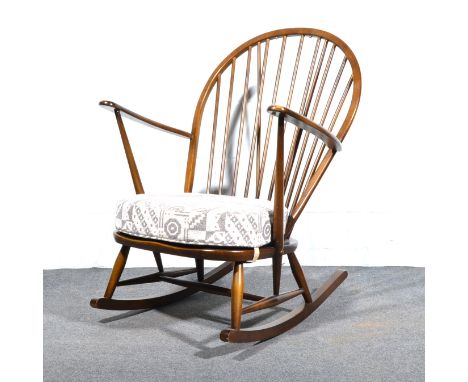 An Ercol stained beech and elm Windsor rocking chair, with removable seat pad