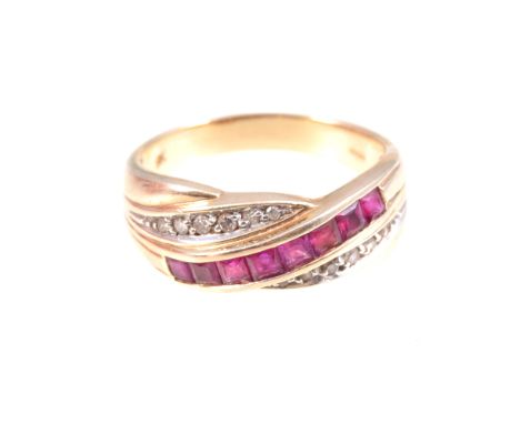 A ruby and diamond dress ring, eight square cut rubies line edge set diagonally with six diamond points set to top and bottom