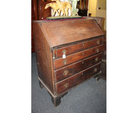 A George III mahogany bureau with fall front enclosing fitted interior of drawers and pigeon holes, four drawers below, on br