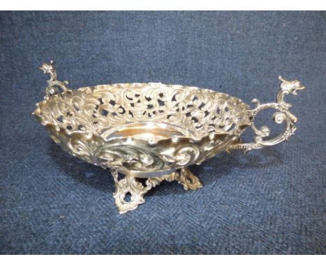 A late Victorian silver fruit bowl by 'Charles Edwards', London 1895, pierced with scrolling leaves, two animal mask scroll h