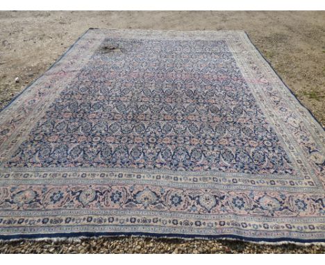 Large Persian carpet with all over floral leaf, palmettes & arabesques on a blue ground (burn hole) 347x416cm PLEASE always c