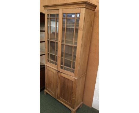 Good pine cupboard bookcase with 2 glazed doors above a pair of panelled doors on bracket feet PLEASE always check condition 