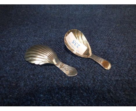 George III shell bowl caddy spoon with bright cut handle by 'Charles Hougham' London 1784 together with a late C18th Irish sh